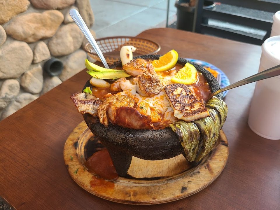 Restaurant menu highlighting mariscos and Sinaloa-style dishes.